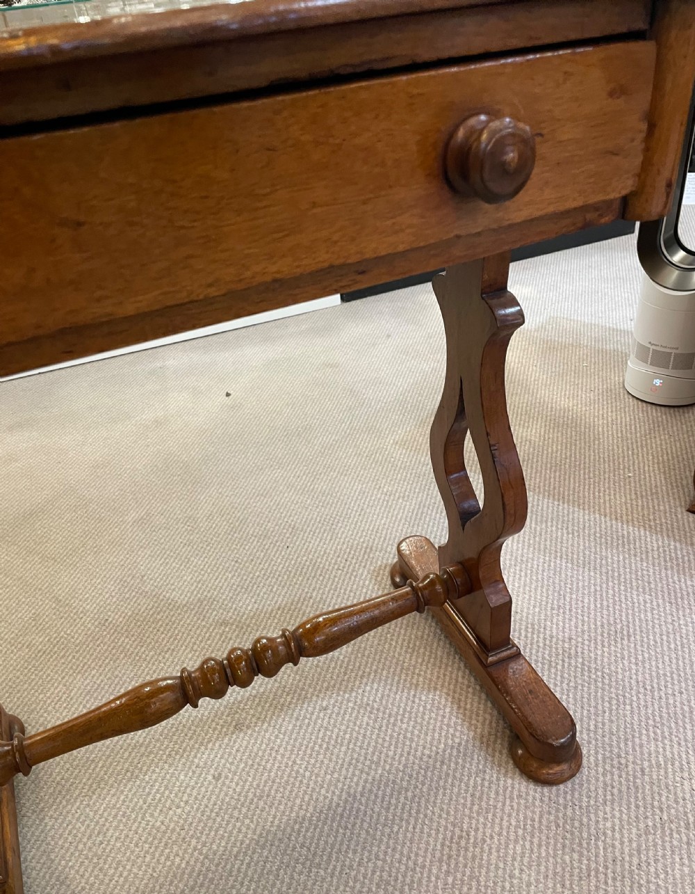 A 19th-century Victorian mahogany occasional table featuring a single drawer with wooden knobs, shaped trestle legs, and a turned stretcher. View VII