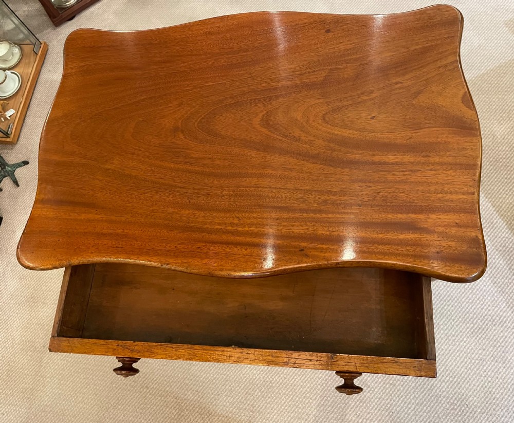 A 19th-century Victorian mahogany occasional table featuring a single drawer with wooden knobs, shaped trestle legs, and a turned stretcher. View VIII