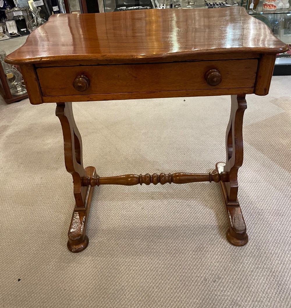 A 19th-century Victorian mahogany occasional table featuring a single drawer with wooden knobs, shaped trestle legs, and a turned stretcher. View IX
