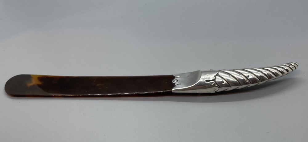 A Victorian letter opener with a spiral-fluted silver handle and a dark brown tortoiseshell blade. View IV
