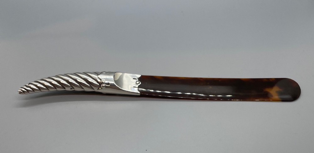 A Victorian letter opener with a spiral-fluted silver handle and a dark brown tortoiseshell blade. View V
