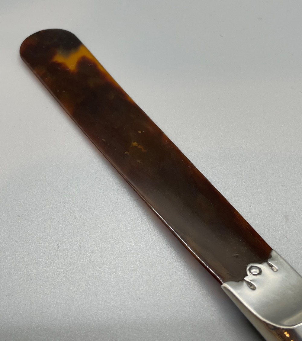A Victorian letter opener with a spiral-fluted silver handle and a dark brown tortoiseshell blade. View VIII