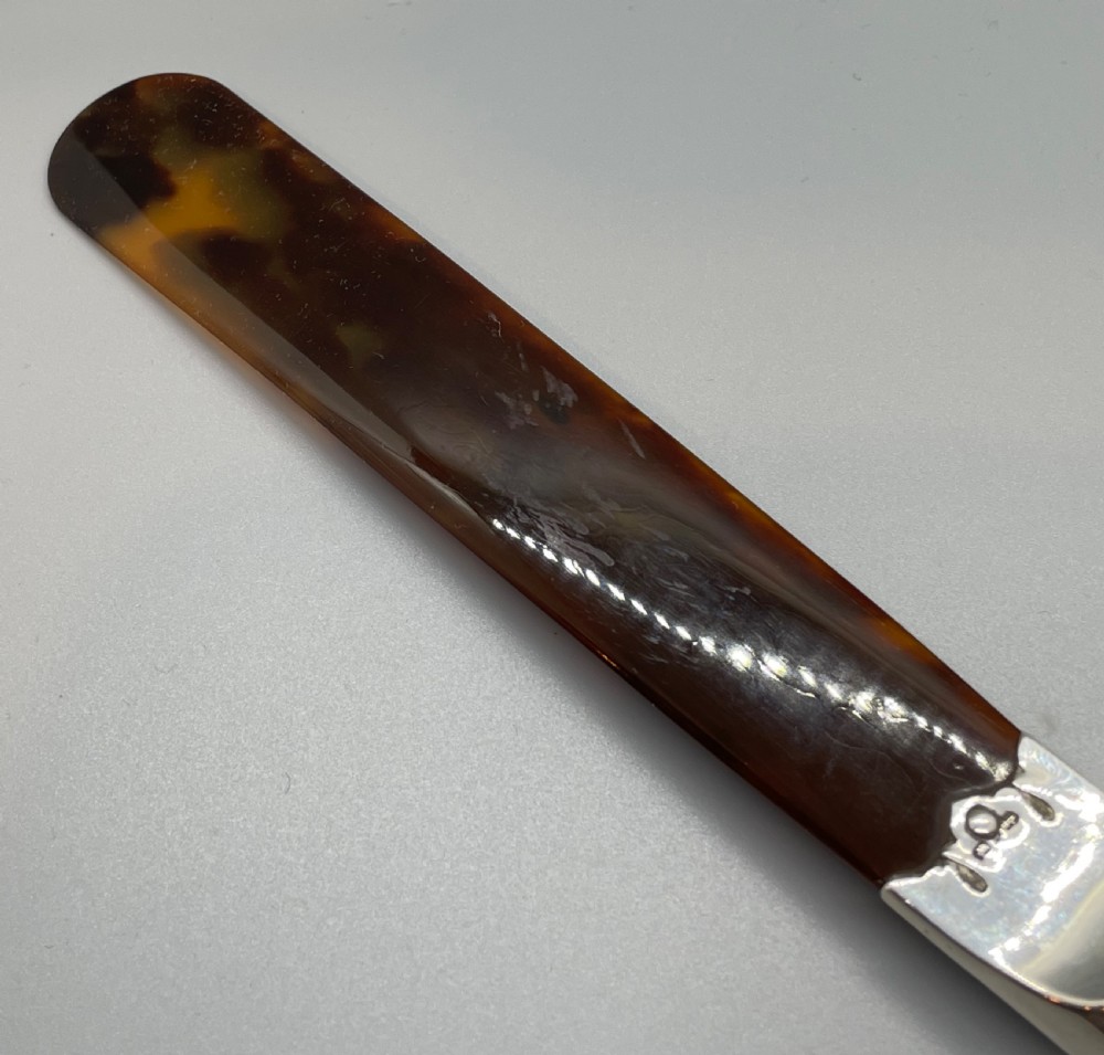 A Victorian letter opener with a spiral-fluted silver handle and a dark brown tortoiseshell blade. View IX