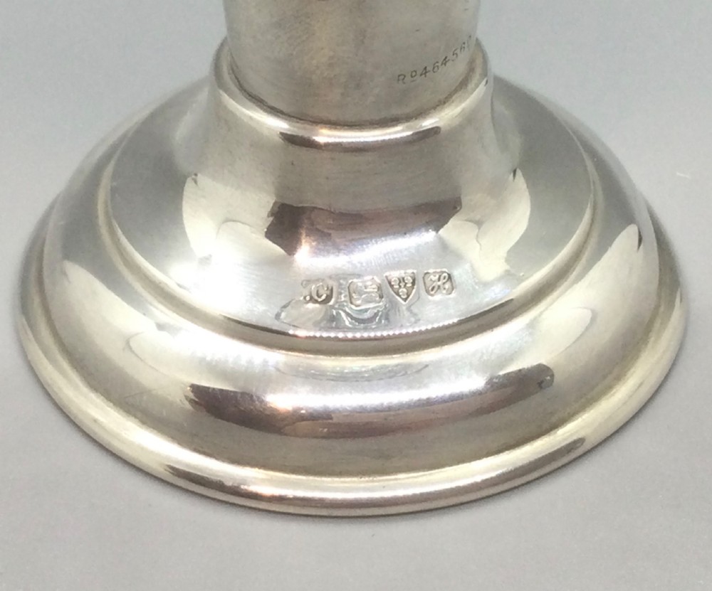 An Edwardian sterling silver vase featuring a pierced lattice body, flared scalloped rim, and a green glass liner. View III