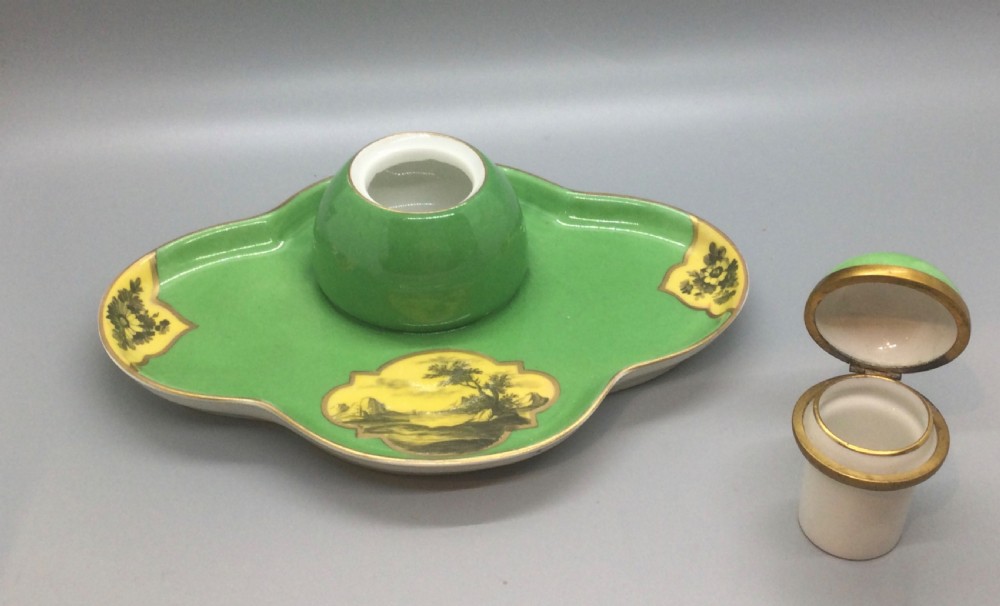 An early 19th-century green and yellow porcelain inkstand featuring a central dome inkwell and hand-painted landscape reserves on a shaped tray. View X