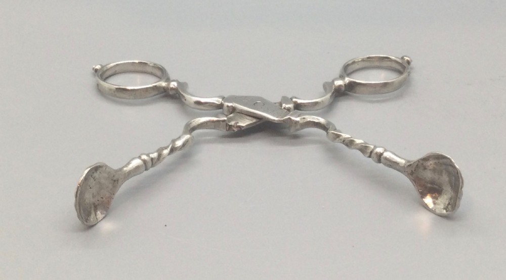 An early Georgian sterling silver scissor-style sugar nip featuring shell-shaped grips and scrolled arms with finger loops. View IV