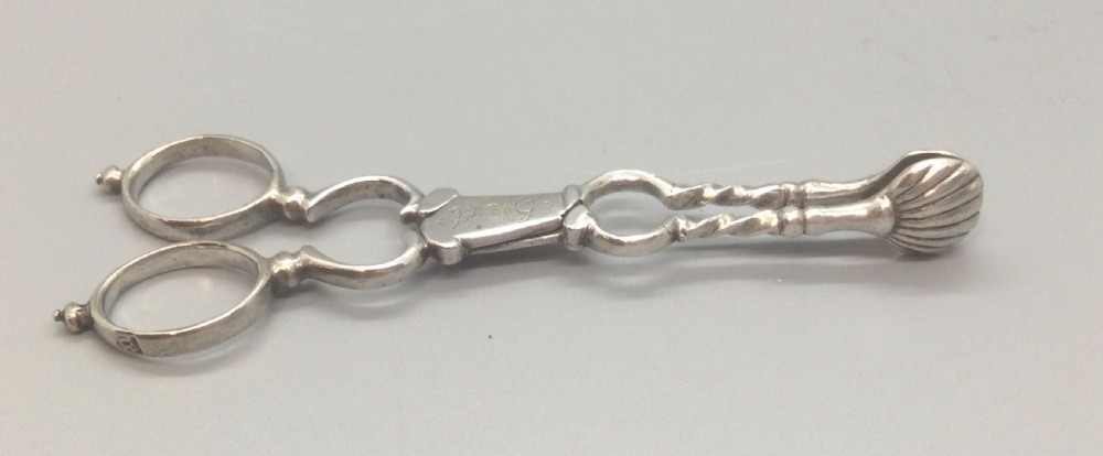 An early Georgian sterling silver scissor-style sugar nip featuring shell-shaped grips and scrolled arms with finger loops. View VIII