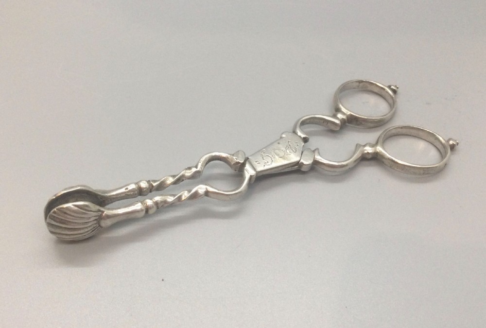 An early Georgian sterling silver scissor-style sugar nip featuring shell-shaped grips and scrolled arms with finger loops. View IX
