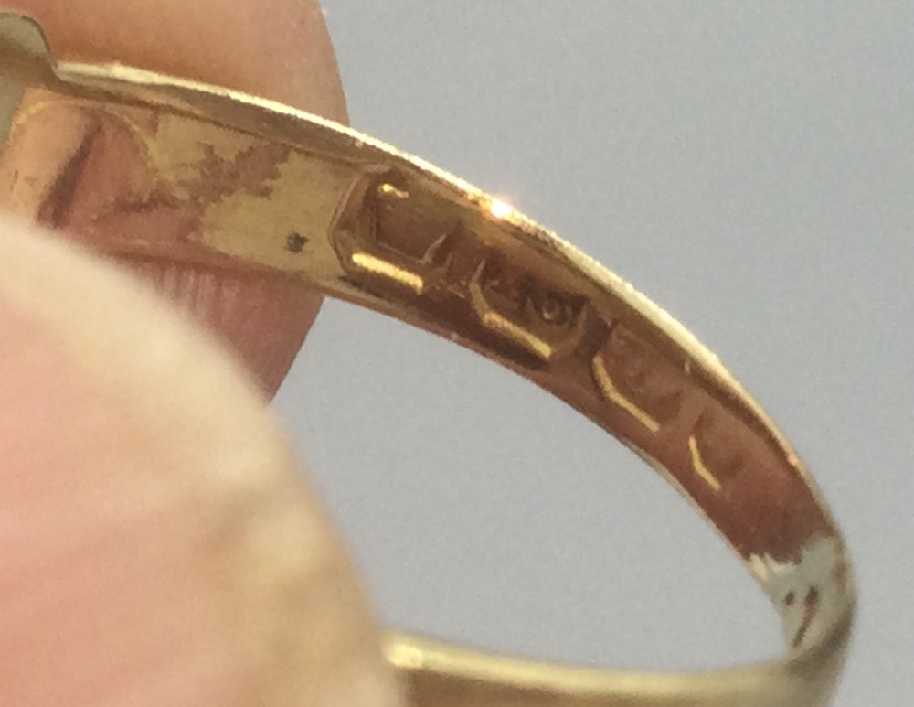 A Victorian 18ct yellow gold ring set with red rubies and small diamonds in a carved boat head setting. View V