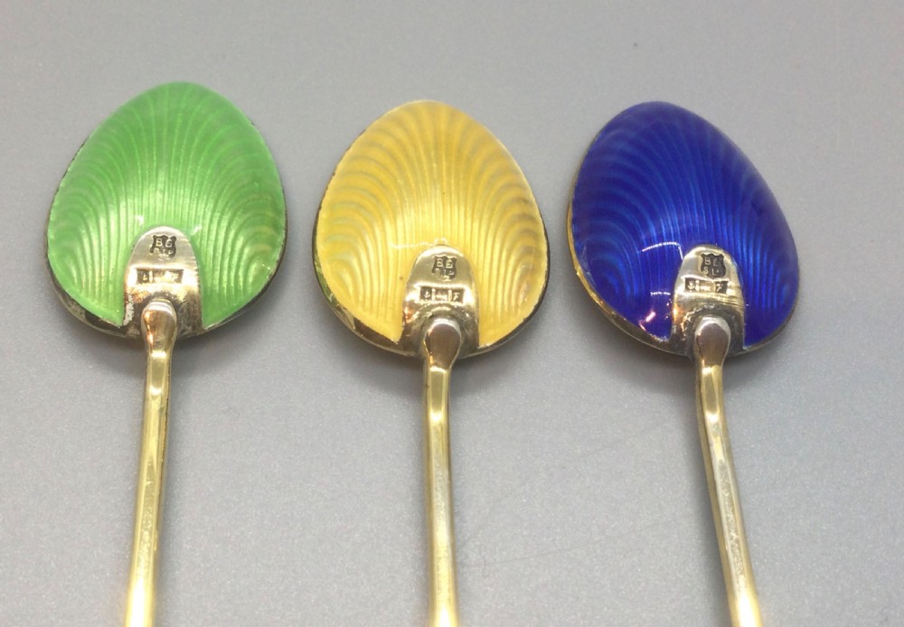 A set of six Art Deco silver gilt coffee spoons featuring colourful guilloche enamel backs, presented in a black velvet-lined case. View VIII
