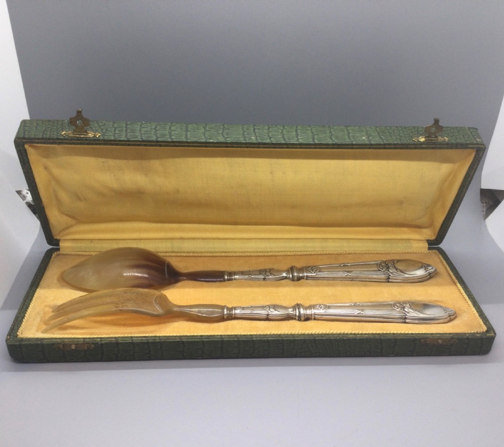 A late nineteenth-century French silver and horn salad serving set presented inside an open green fitted box with yellow lining. View IX