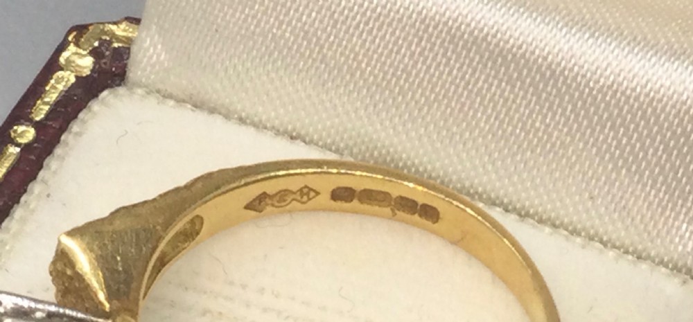 A vintage 18ct yellow gold solitaire ring featuring a textured bark-effect band and a central diamond in a claw setting. View VI