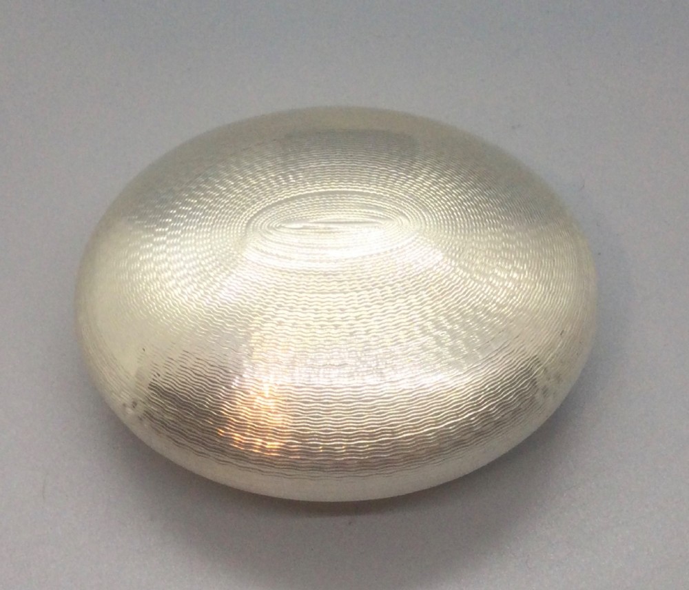 An oval Victorian sterling silver snuff box with engine-turned geometric engraving and a central vacant cartouche on top. View VI
