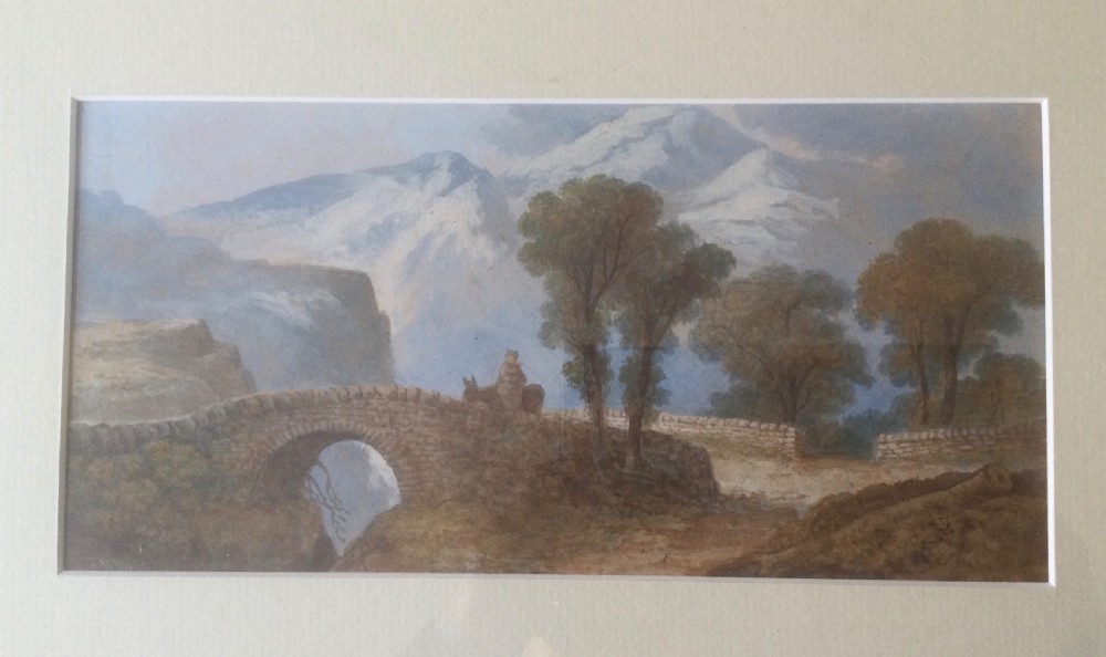 A 19th-century framed watercolour landscape painting featuring a stone arch bridge, trees, and distant mountains. View II