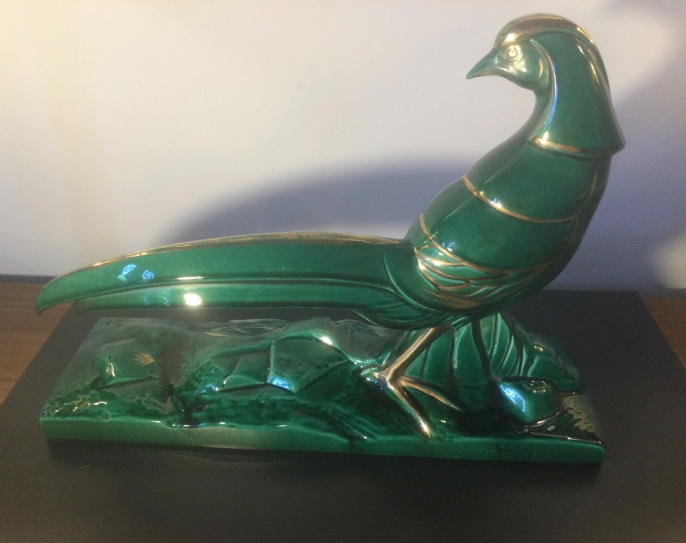 A stylised Art Deco green glazed ceramic pheasant figurine featuring fine gold line details and an extended sweeping tail resting on an integrated base. View IV