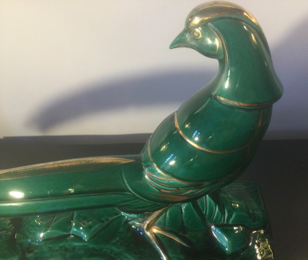 A stylised Art Deco green glazed ceramic pheasant figurine featuring fine gold line details and an extended sweeping tail resting on an integrated base. View V