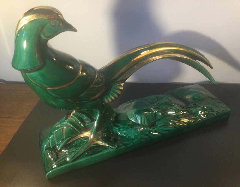 A stylised Art Deco green glazed ceramic pheasant figurine featuring fine gold line details and an extended sweeping tail resting on an integrated base. View VII