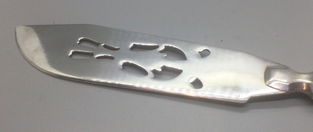 A pair of French silver-plated Art Deco cake servers with ribbed handles and pierced blades inside a white satin-lined presentation case. View VIII