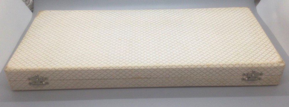 A pair of French silver-plated Art Deco cake servers with ribbed handles and pierced blades inside a white satin-lined presentation case. View X