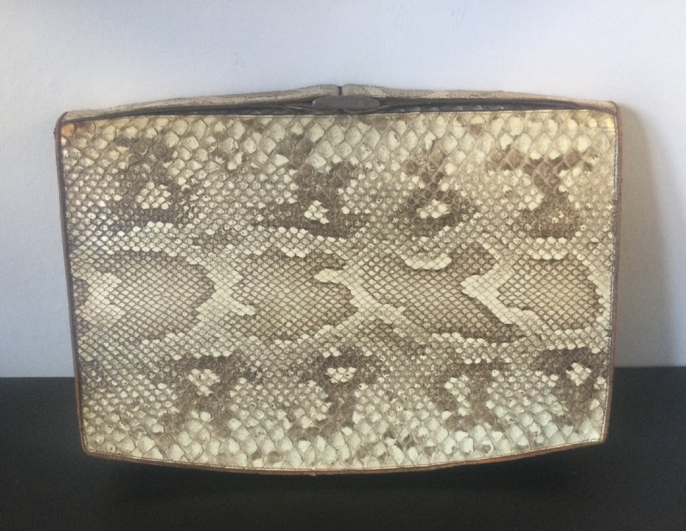 A 1930s rectangular python skin clutch bag featuring natural cream and brown mottled scales and a metal top clasp. View II