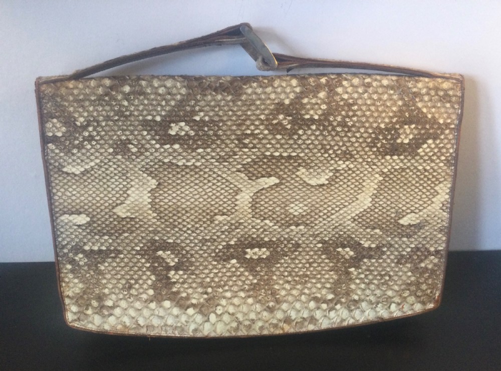 A 1930s rectangular python skin clutch bag featuring natural cream and brown mottled scales and a metal top clasp. View IV