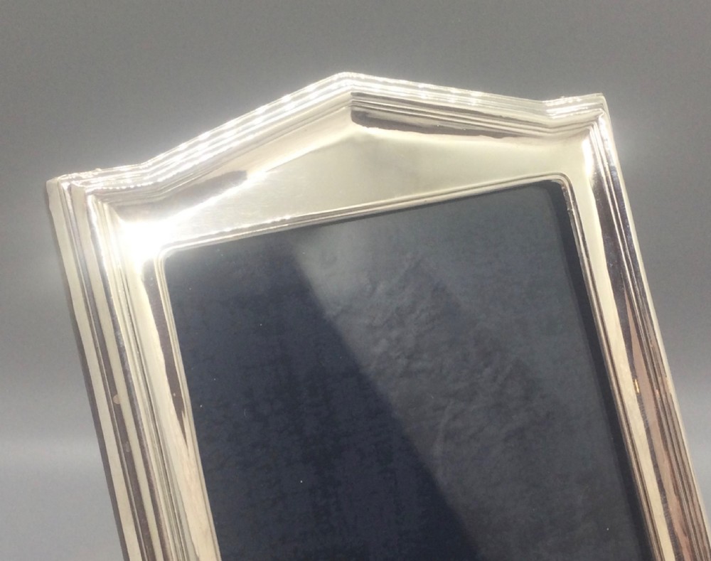 An Art Deco sterling silver picture frame featuring a stepped gabled top moulding and an easel back support. View VII