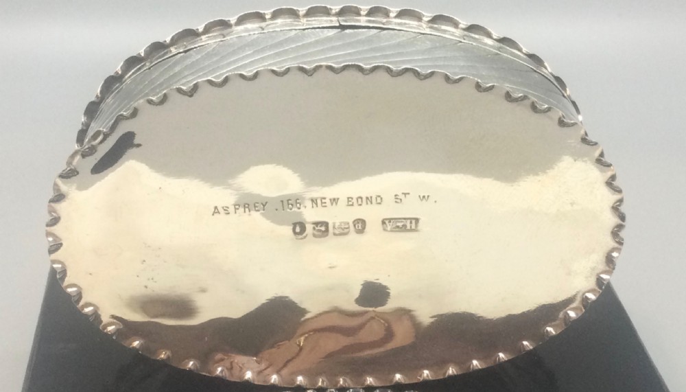 An oval Victorian sterling silver pill box with spiral fluted detailing and a plain central cartouche on the lid. View V