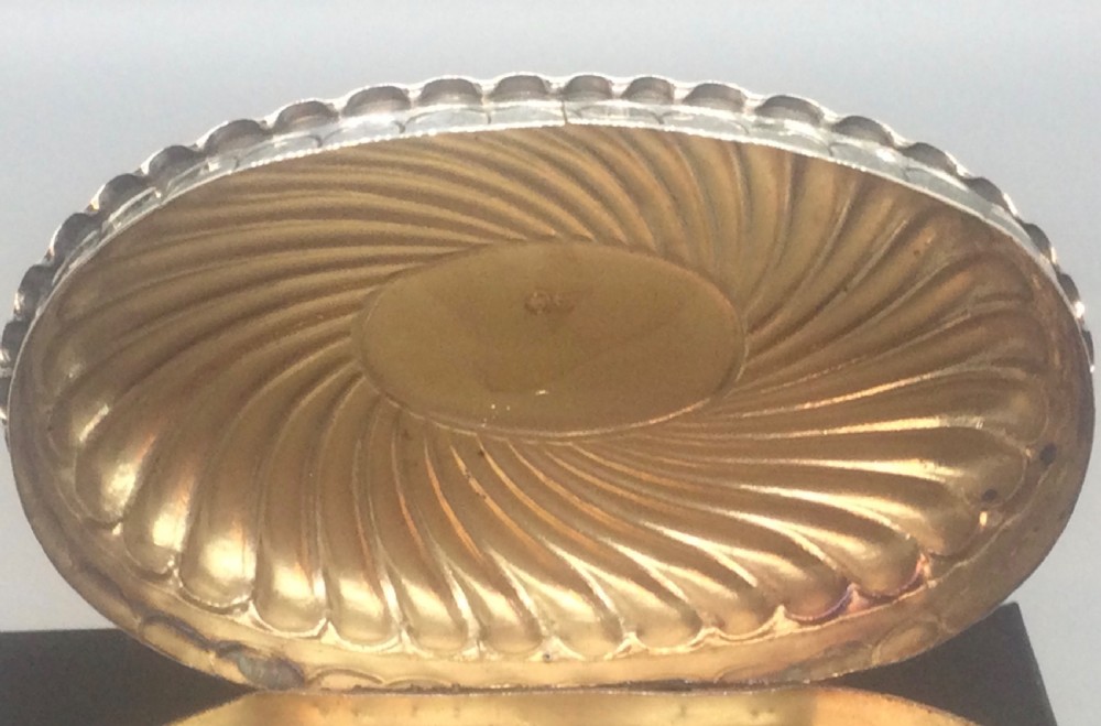 An oval Victorian sterling silver pill box with spiral fluted detailing and a plain central cartouche on the lid. View VII