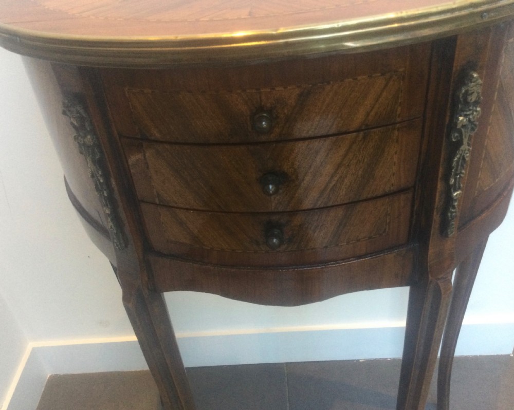 A late 19th-century French kingwood demi-lune console table featuring three drawers with geometric parquetry veneer, brass mounts, and long cabriole legs. View II