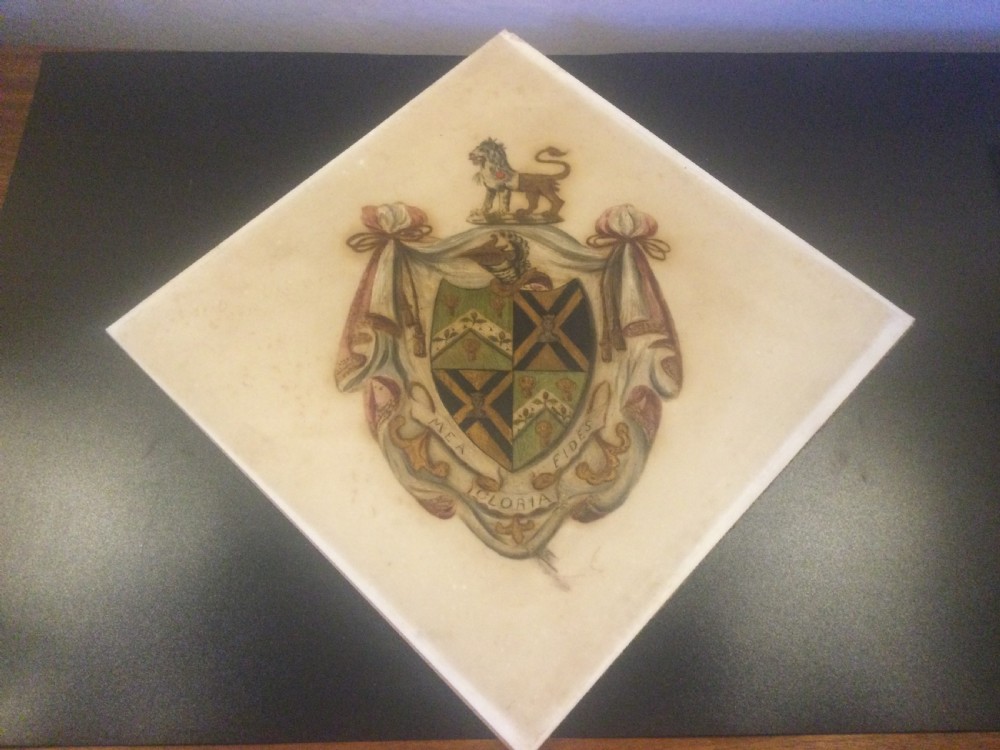 A diamond-shaped gilded frame housing a 19th-century oil painting on glass of an armorial crest with a lion, shield, and Latin motto banner. View IV