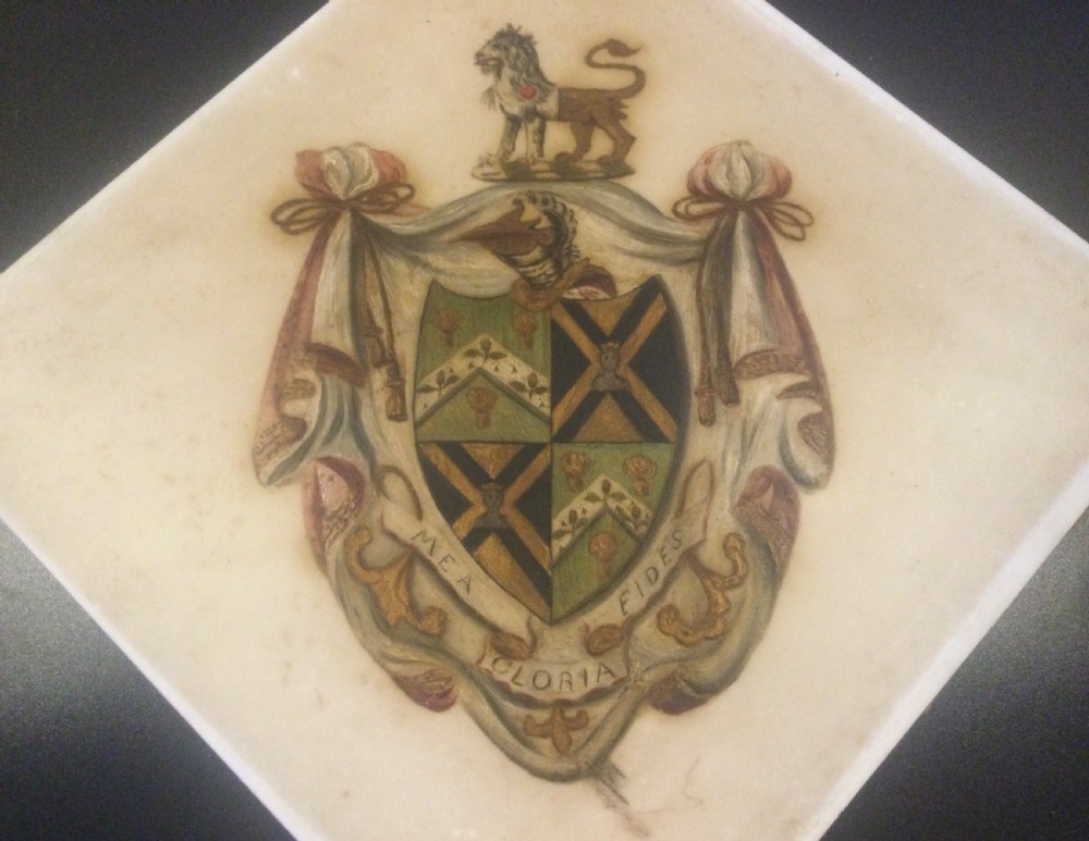 A diamond-shaped gilded frame housing a 19th-century oil painting on glass of an armorial crest with a lion, shield, and Latin motto banner. View V
