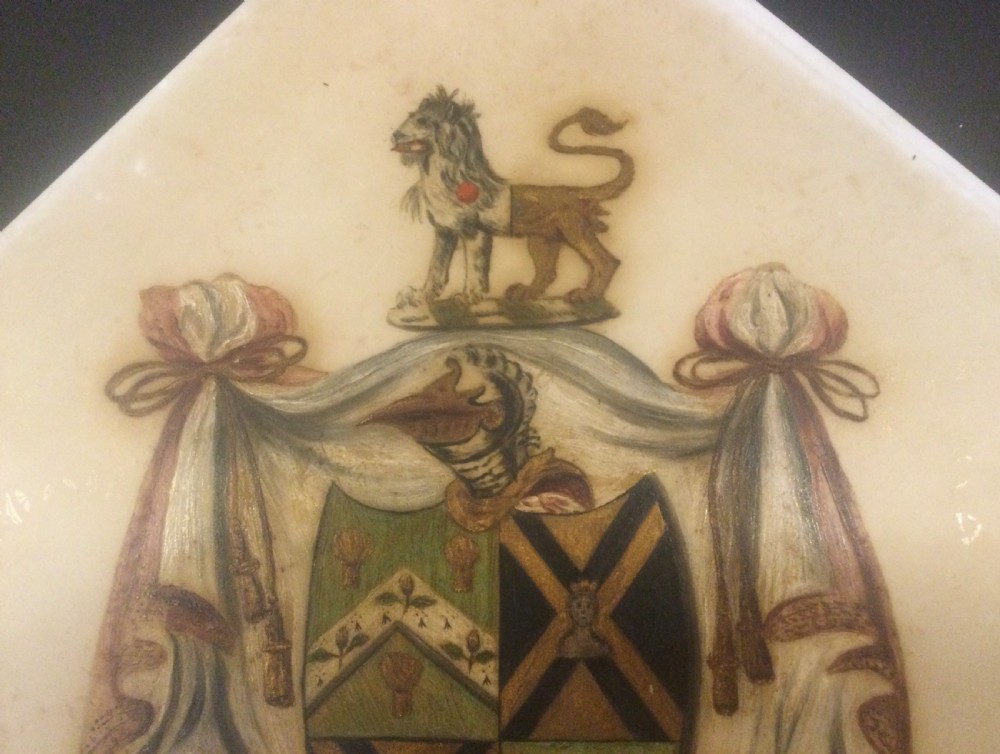 A diamond-shaped gilded frame housing a 19th-century oil painting on glass of an armorial crest with a lion, shield, and Latin motto banner. View VI