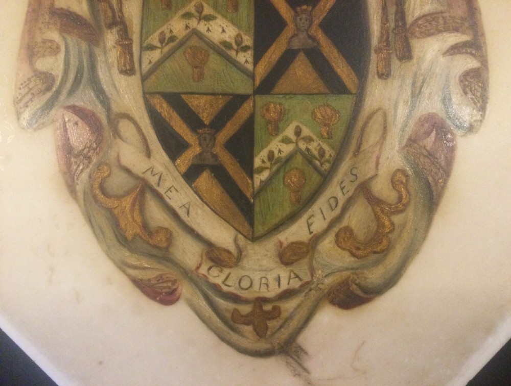A diamond-shaped gilded frame housing a 19th-century oil painting on glass of an armorial crest with a lion, shield, and Latin motto banner. View VII