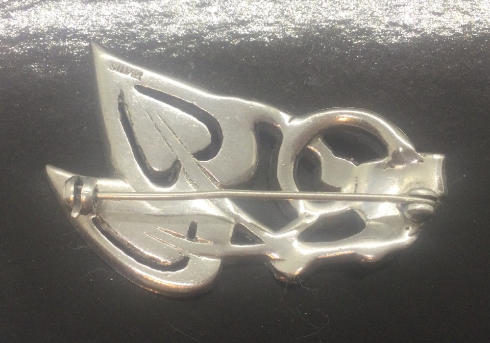 An Art Deco silver marcasite brooch featuring two stylised overlapping hearts connected with swirling ribbon motifs. View III