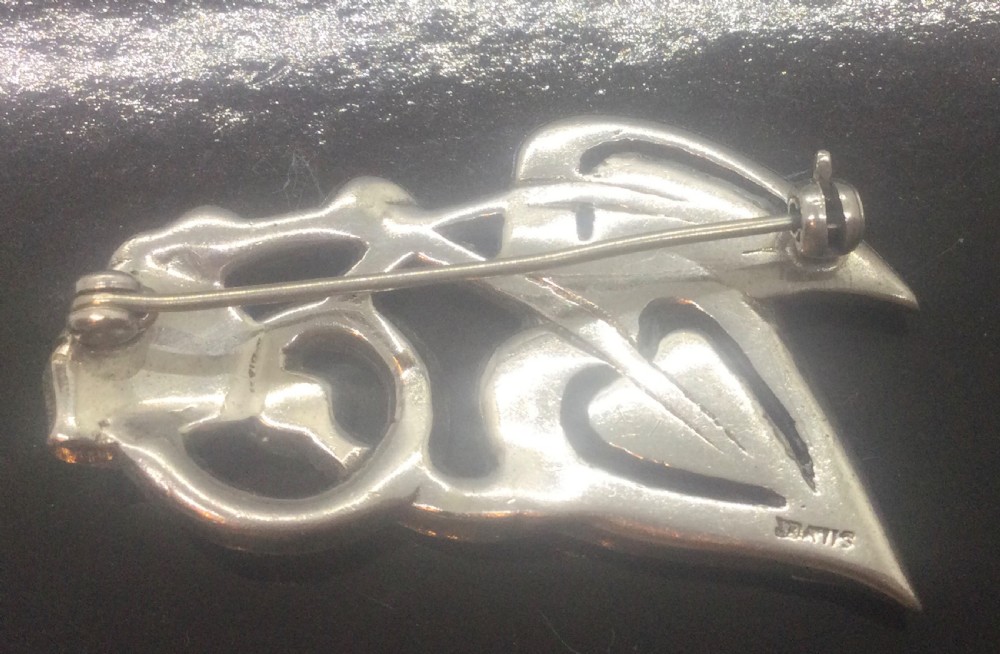 An Art Deco silver marcasite brooch featuring two stylised overlapping hearts connected with swirling ribbon motifs. View IV