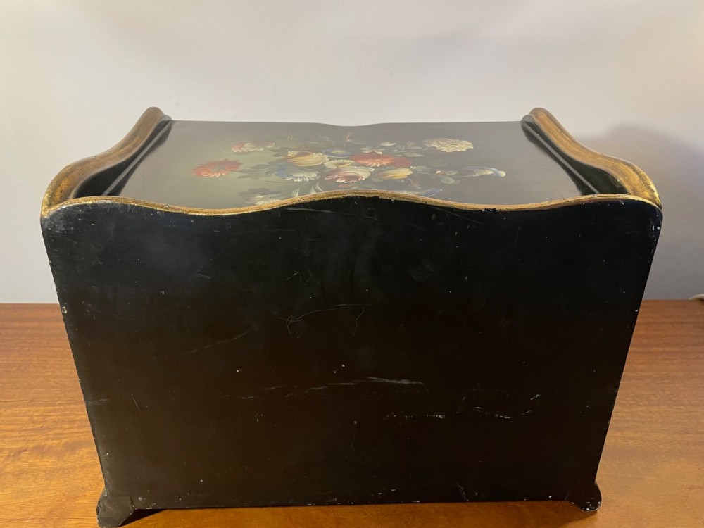 A black lacquered wooden desktop paper sorter featuring five tiered shelf slots, hand-painted floral decoration on top, and a carved gilt moulding frame. View XI