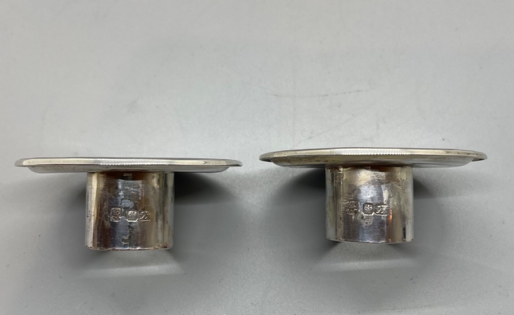 A pair of Victorian sterling silver candlesticks featuring fluted tapered shafts, sconces with reeded rims, and circular lobed bases. View XIII