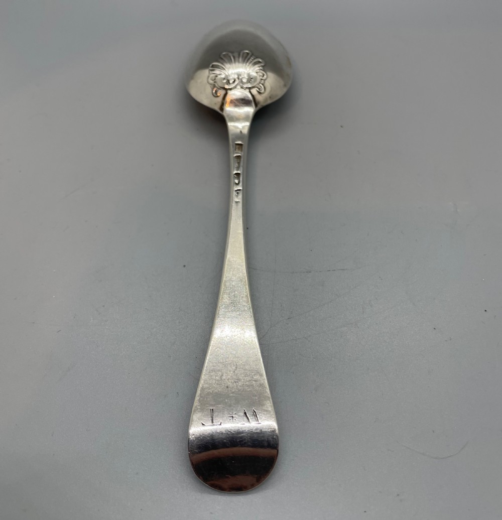 A George II sterling silver tablespoon featuring a classic Hanoverian pattern with an upturned stem and polished oval bowl. View II