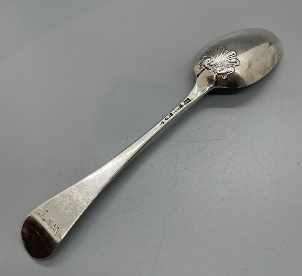 A George II sterling silver tablespoon featuring a classic Hanoverian pattern with an upturned stem and polished oval bowl. View IV