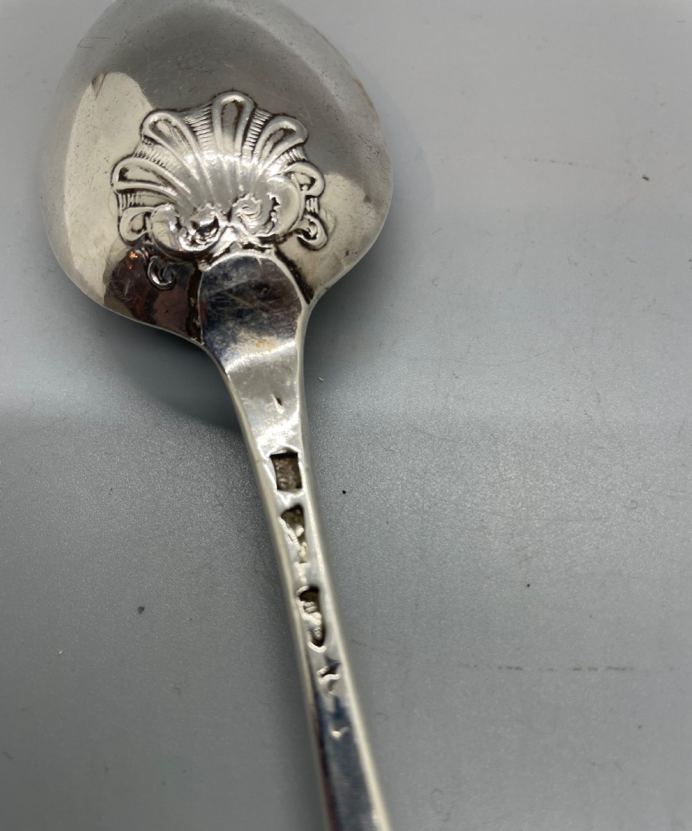 A George II sterling silver tablespoon featuring a classic Hanoverian pattern with an upturned stem and polished oval bowl. View V
