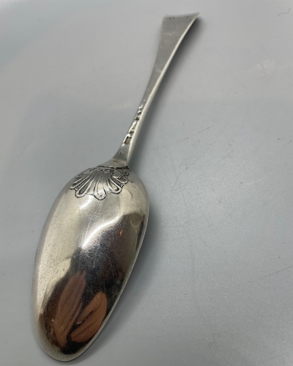 A George II sterling silver tablespoon featuring a classic Hanoverian pattern with an upturned stem and polished oval bowl. View VI