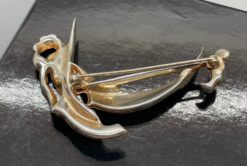 A 1940s sterling silver gilt brooch in the shape of a sailing yacht set with clear, light blue, and red rhinestones. View VII