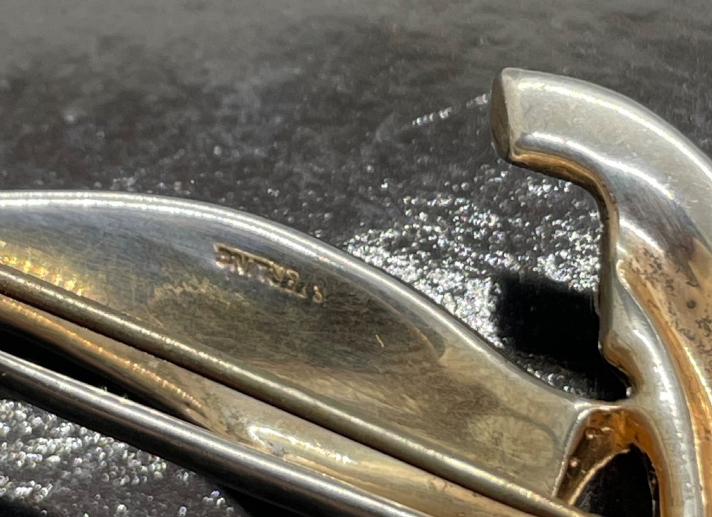 A 1940s sterling silver gilt brooch in the shape of a sailing yacht set with clear, light blue, and red rhinestones. View VIII