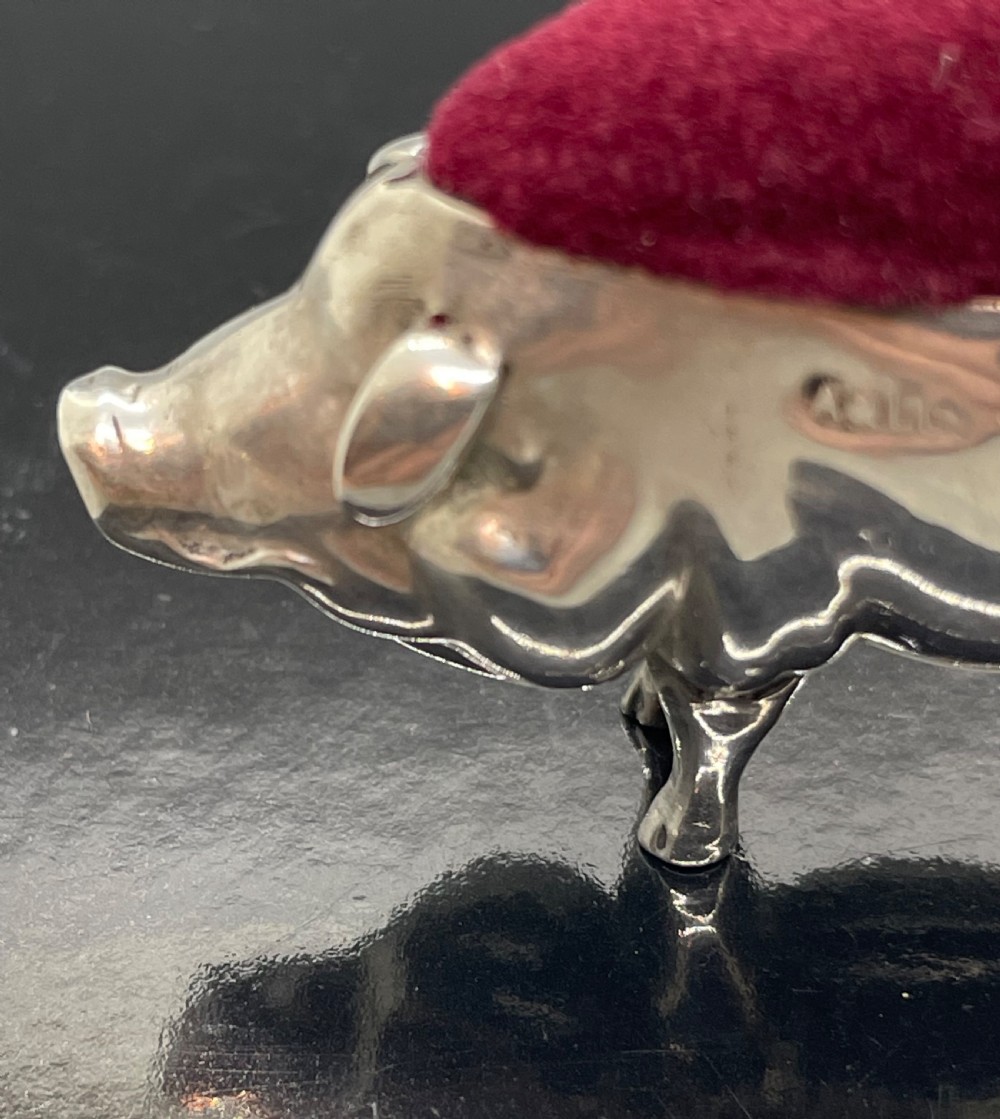 An Edwardian sterling silver pin cushion modelled in the shape of a standing pig with a red velvet pad on its back. View IV