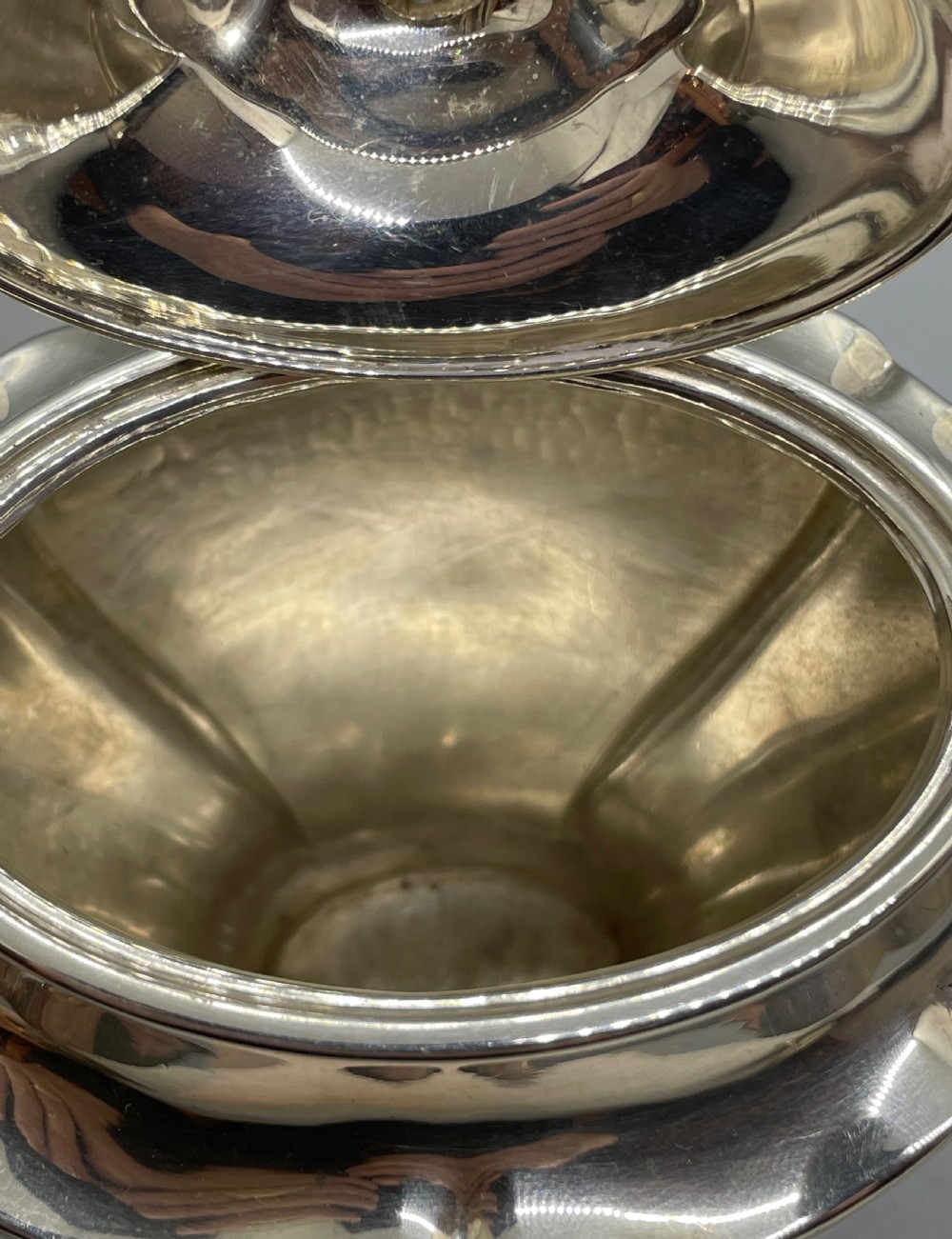 A George V sterling silver tea caddy with a lobed pedestal body, fitted lid, and a dark wooden finial. View VIII