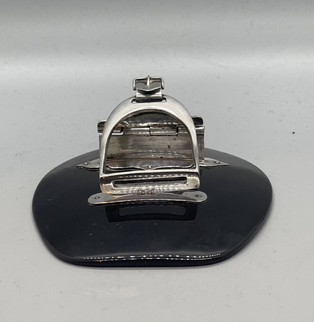 An Edwardian sterling silver letter clip styled as an equestrian stirrup on a smooth dark tortoiseshell base. View II