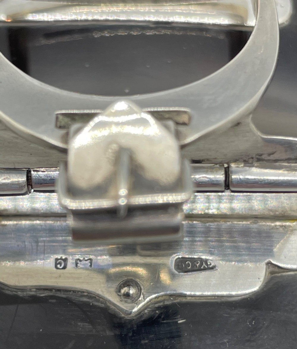 An Edwardian sterling silver letter clip styled as an equestrian stirrup on a smooth dark tortoiseshell base. View IX