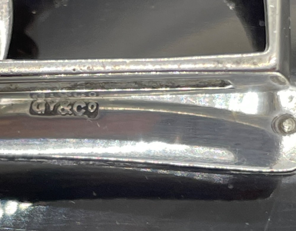 An Edwardian sterling silver letter clip styled as an equestrian stirrup on a smooth dark tortoiseshell base. View XI