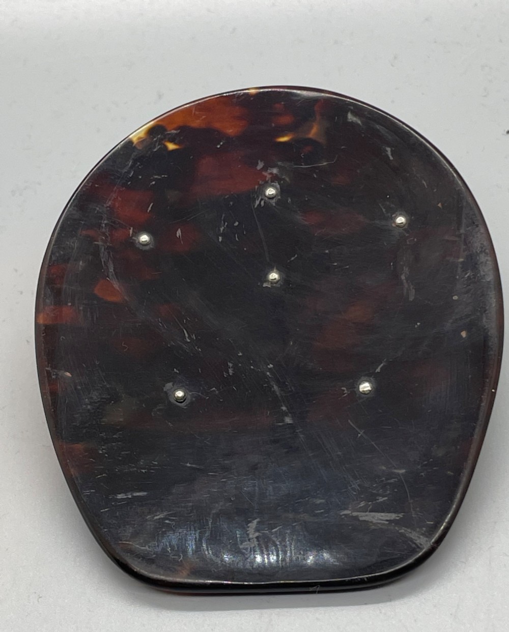 An Edwardian sterling silver letter clip styled as an equestrian stirrup on a smooth dark tortoiseshell base. View XIV