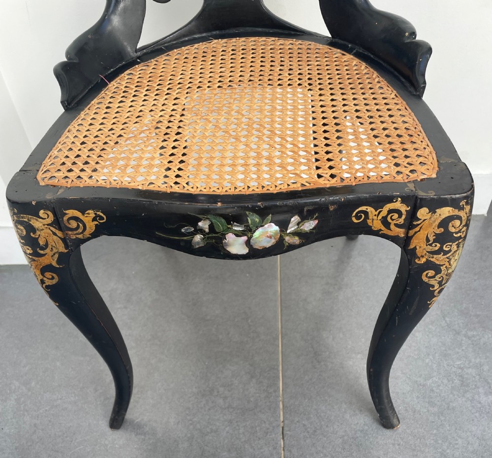 A Victorian ebonised side chair featuring floral mother-of-pearl inlays, gold leaf scrollwork decoration, a shaped back rest, cabriole front legs, and a woven cane seat. View IV